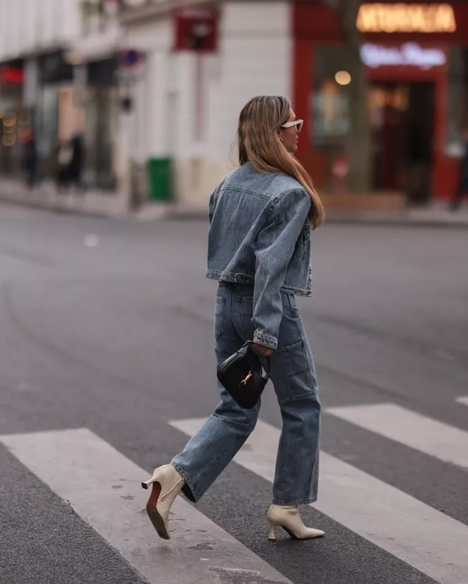 A cropped blue denim jacket and matching blue jeans worn with pale pointed ankle boots